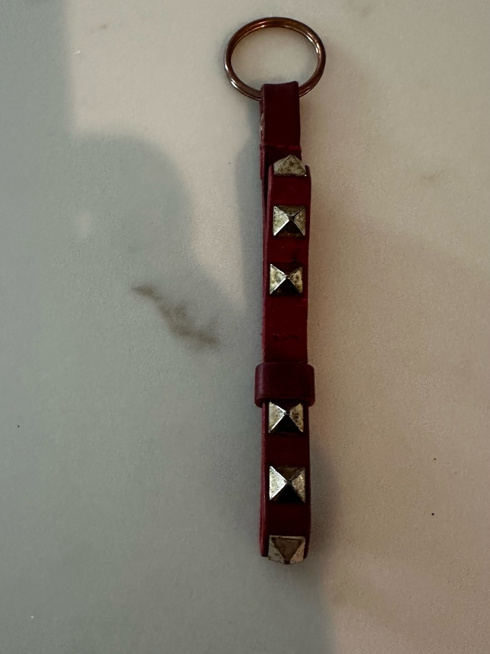 Valentino Garavani Rockstud Key chain Strap in Red with Gold Studs.